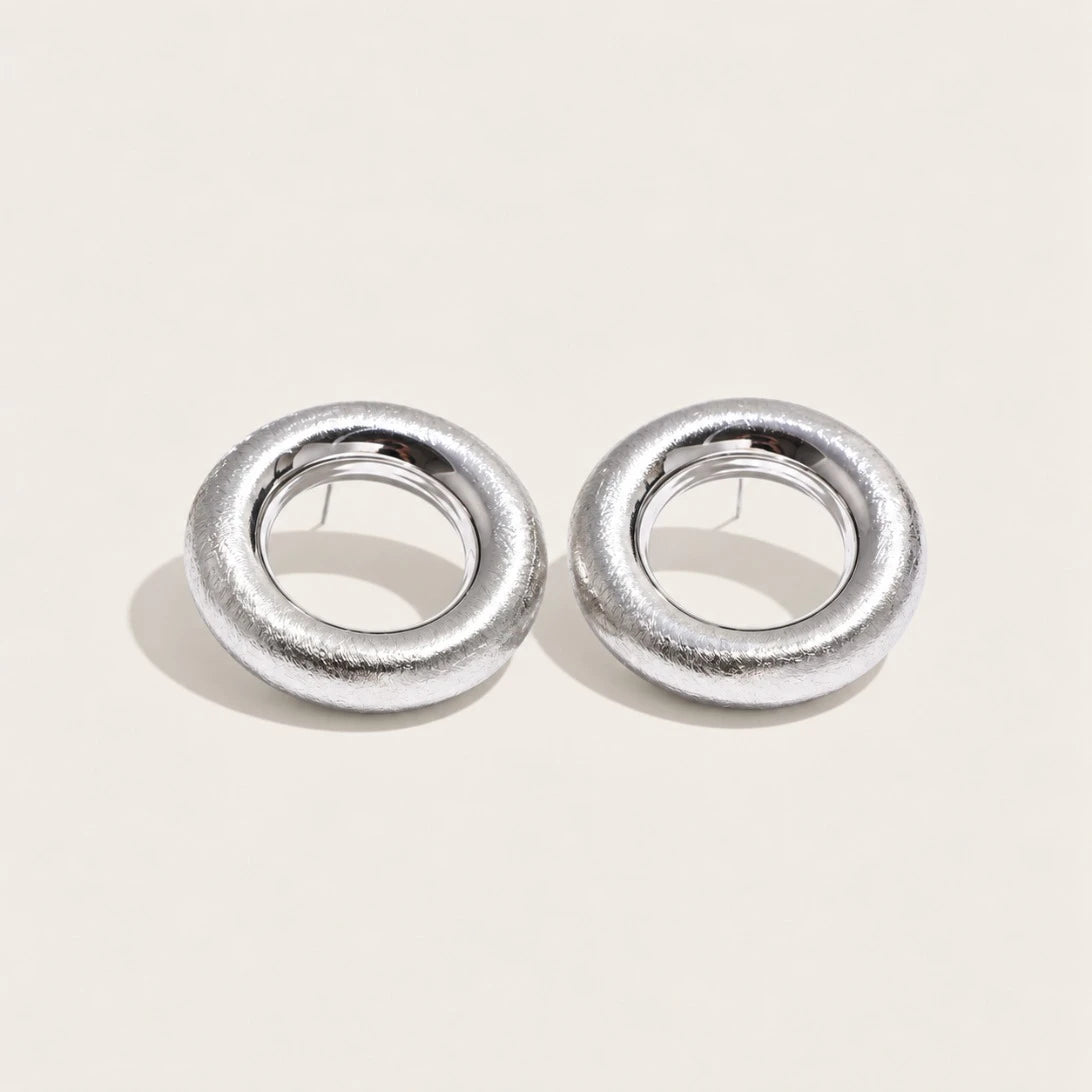 Silver-tone Anello EARRINGS: a pair of bold, rounded ring-shaped earrings with a textured surface — Folie à Trois