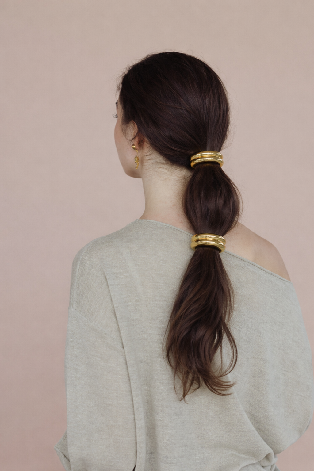 Bridgette Hair Tie worn stacked, two ridged gold beads down a low ponytail, sage green sweater.