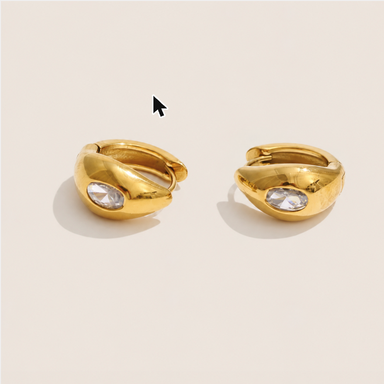 Gold chunky huggie hoop earrings with a bezel-set marquise white zirconia stone on a cream backdrop — Folie à Trois Cascade EARRINGS
