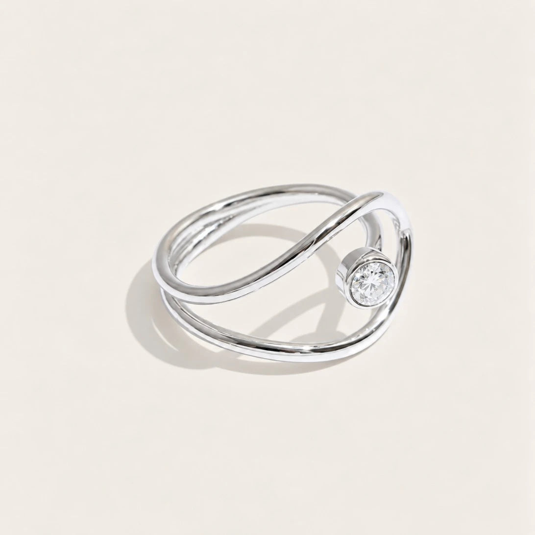 Silver-tone Cercle RING: a slim band looping into an open circle that frames a white zirconia stone — Folie à Trois