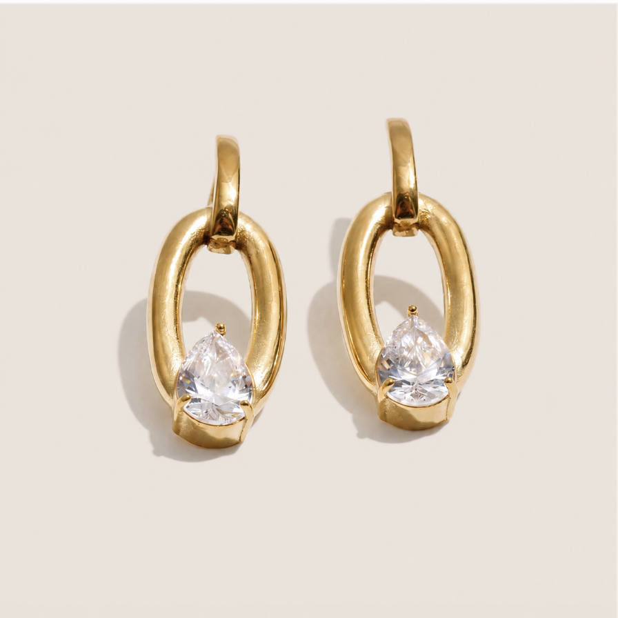 Gold oval chain-link drop earring with a pear-cut white zirconia stone bezel-set near the base — Folie à Trois Curve EARRINGS.