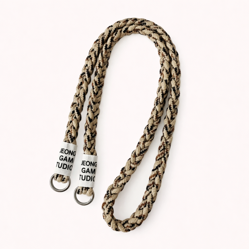 Beige and brown camo-print braided cord Havana long phone strap, coiled with silver ring hardware.