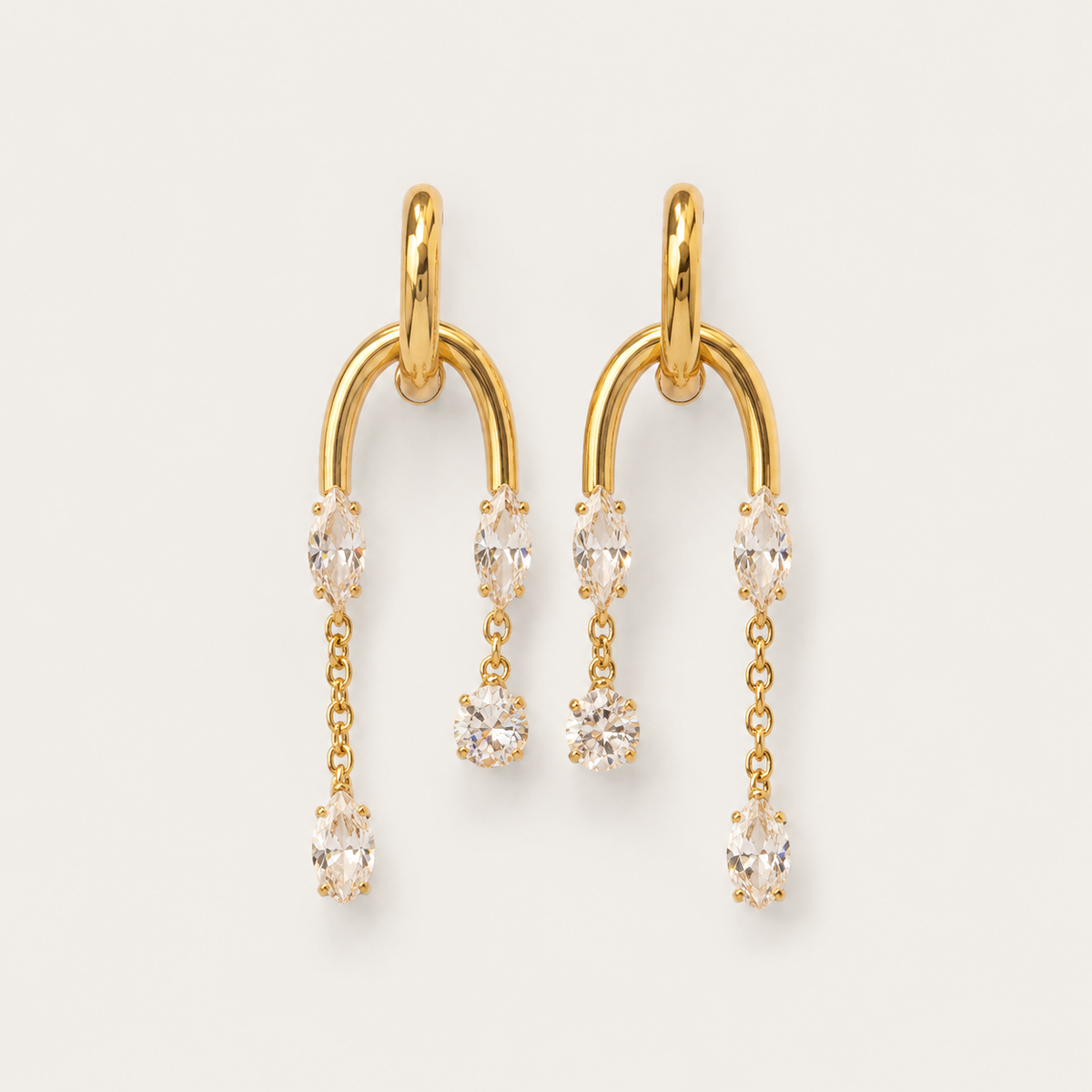 Gold arched drop earring with marquise and round white zirconia stones cascading in a delicate line — Folie à Trois Luce EARRINGS.