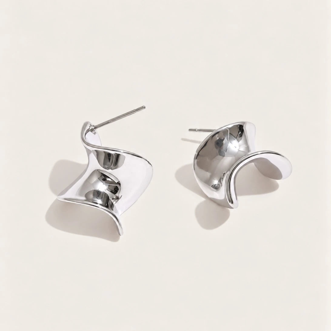 Silver-tone Ribbon EARRINGS: a pair of small studs shaped like a twisted, wavy ribbon bow — Folie à Trois