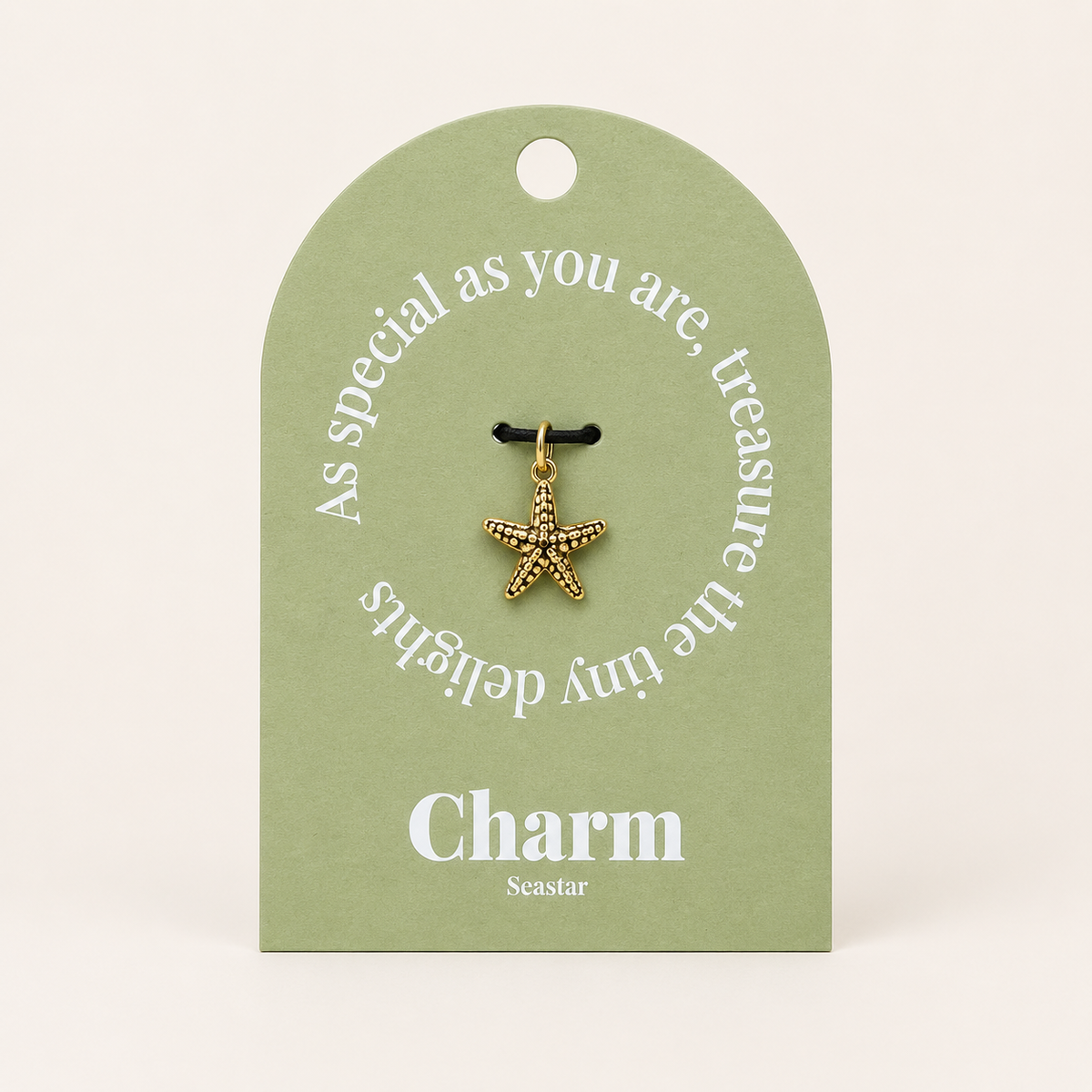 The Seastar CHARM displayed on a sage green Charm gift tag, hanging from a black cord against the card text As special as you are.