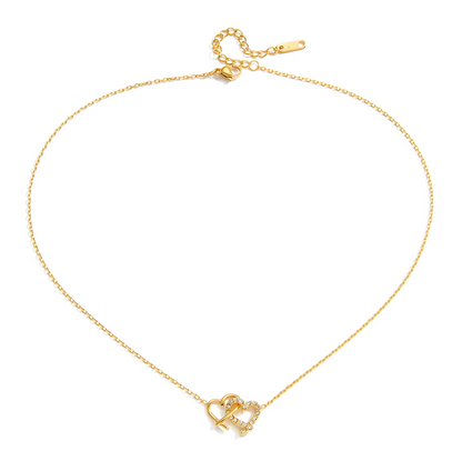 Gold-plated necklace with a delicate chain and interlocking heart-shaped pendant embellished with clear crystals