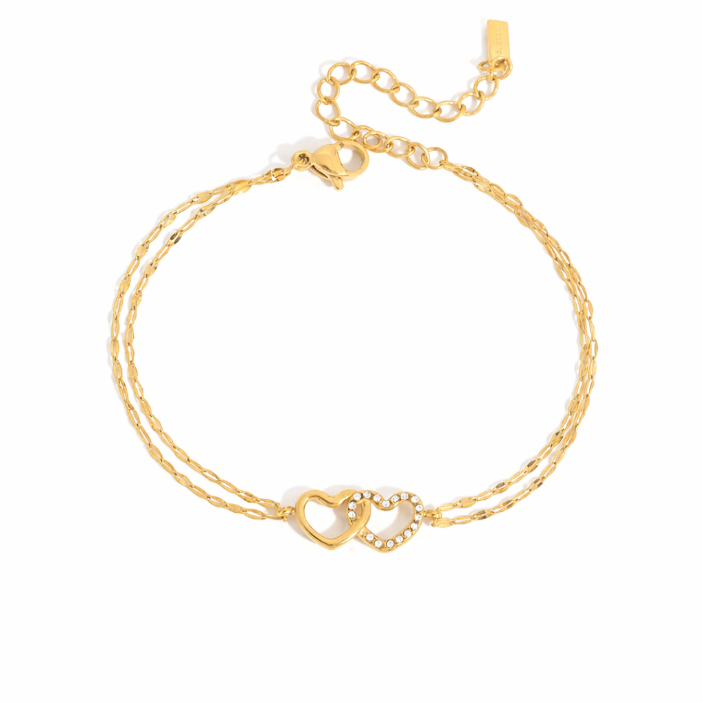 Gold-plated double-chain bracelet with two intertwined heart charms, one polished and one set with clear crystal stones