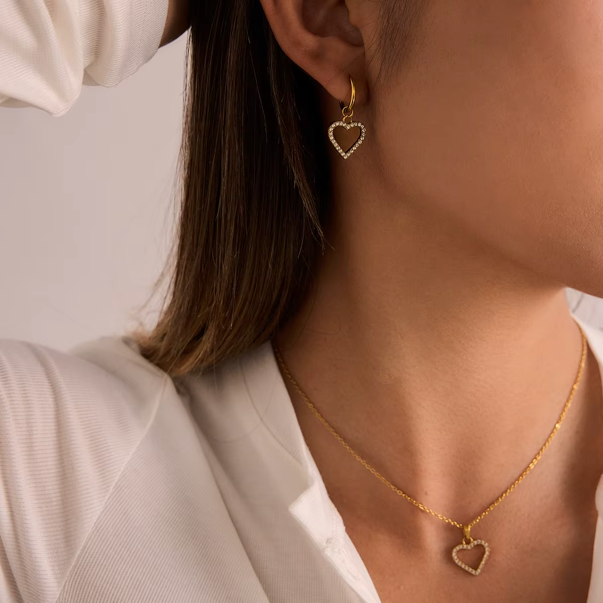 Gold-plated necklace with a delicate chain and an open heart pendant outlined with clear crystal stones