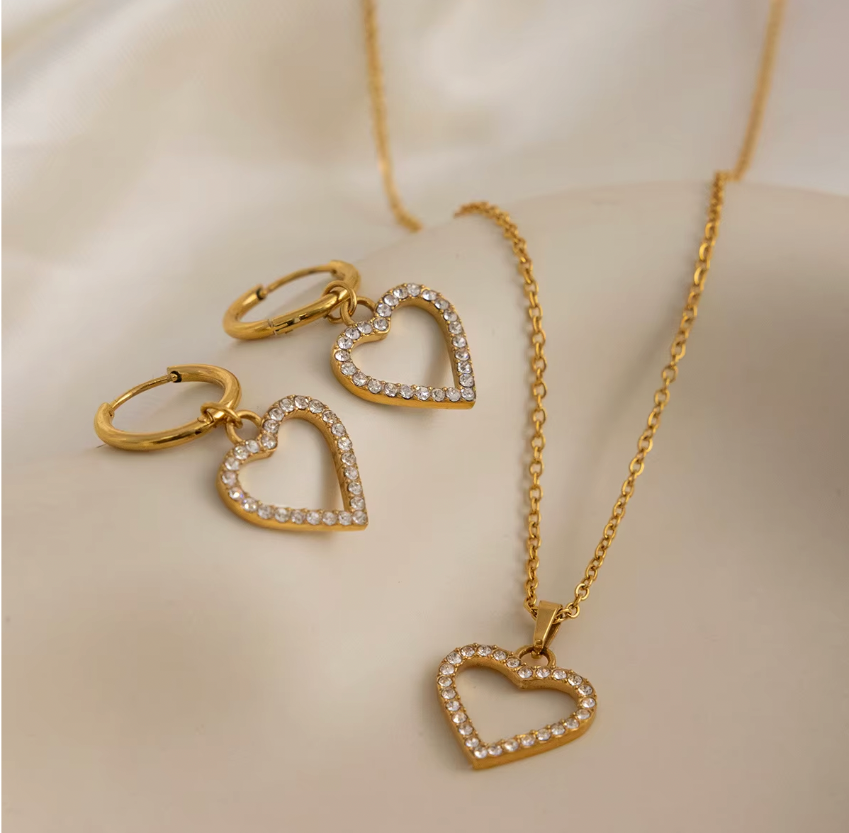 Gold-plated necklace with a delicate chain and an open heart pendant outlined with clear crystal stones