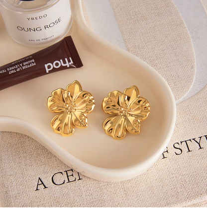 Gold-plated flower-shaped stud earrings with sculpted petals and a polished finish