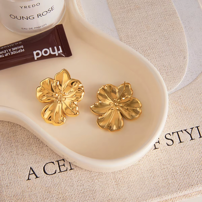 Gold-plated flower-shaped stud earrings with sculpted petals and a polished finish