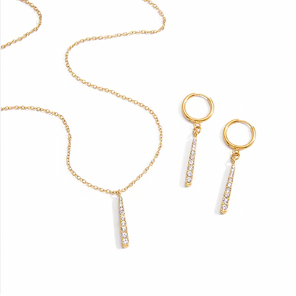 Gold-plated huggie earrings with slim vertical bar pendants set with clear crystal stones