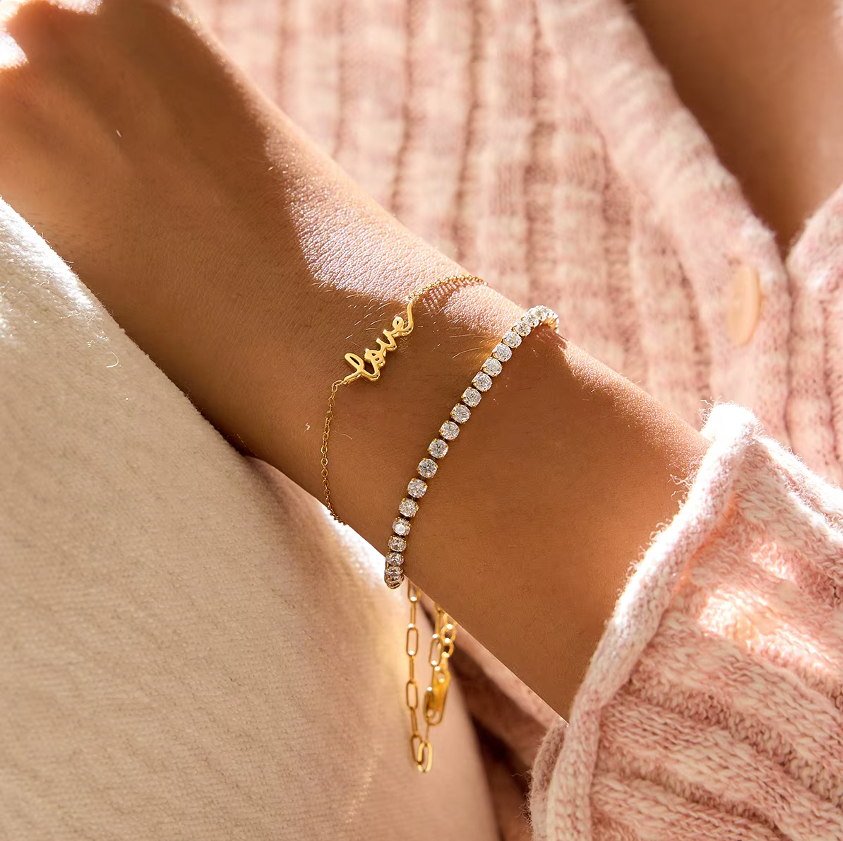 Gold-plated bracelet with a delicate chain and “love” script charm