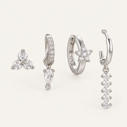 The Folie à Trois Adele SET in silver: a trio stud, a pavé huggie with crystal drop, a flower hoop and a beaded dangle hoop.