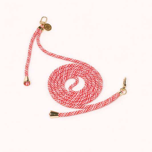 Red and white patterned Aesthetic Colorful PHONE CORD coiled with gold hardware and a charm, shown as a flat lay.