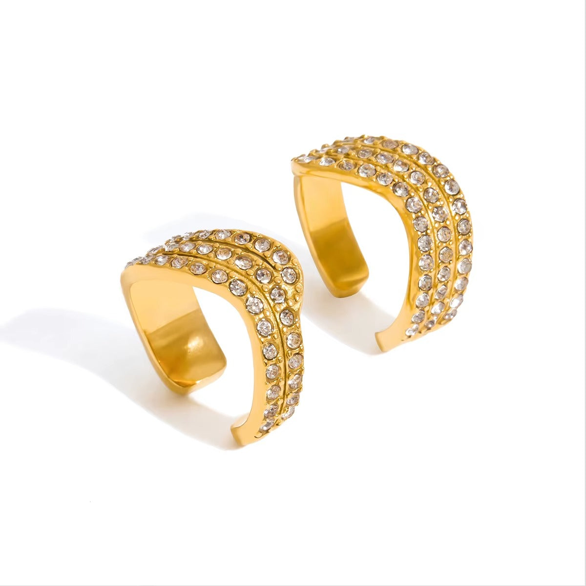 A pair of Afterparty Ear Cuffs shown together, each a wide open gold band paved with three rows of sparkling crystals.
