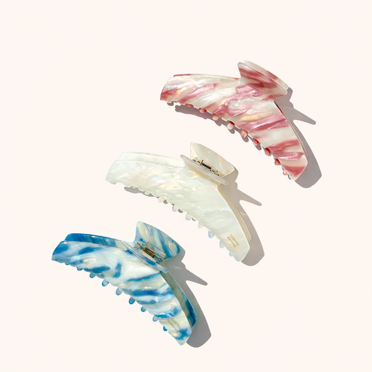 Alba HAIR CLIP three wing-shaped acetate claw clips in pink, cream and blue striped patterns, studio shot.