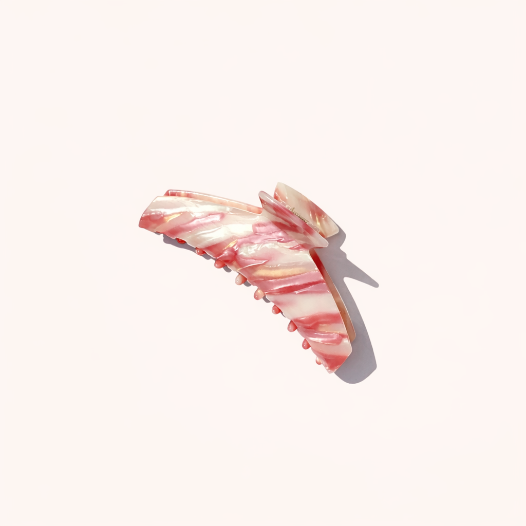 Alba HAIR CLIP wing-shaped acetate claw clip in a pink and cream striped pattern, studio shot.