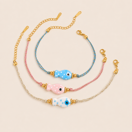 Amalfi BRACELET set with three ceramic polka-dot fish charms in blue, pink, and white on twisted cord bands, shown together.