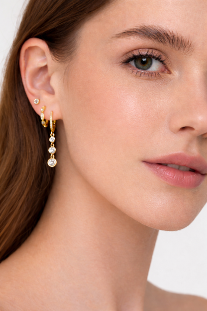Worn along the ear, the Amelie SET layers a bezel stud with a pave hoop trailing three crystal drops.