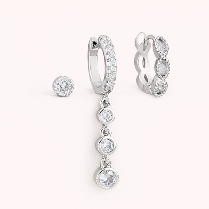 The Amelie SET is shown in silver: a bezel stud, a pave hoop with crystal drops, and a marquise huggie.