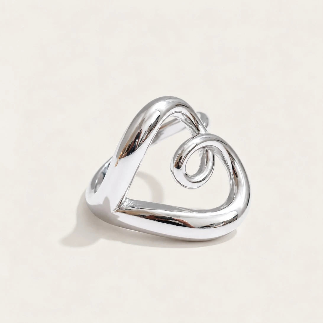 Silver-tone Amore RING: a rounded open band that twists and curls into a heart outline — Folie à Trois