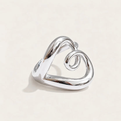 Silver-tone Amore RING: a rounded open band that twists and curls into a heart outline — Folie à Trois