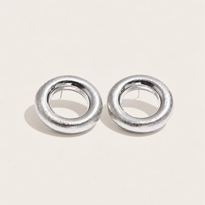 Silver-tone Anello EARRINGS: a pair of bold, rounded ring-shaped earrings with a textured surface — Folie à Trois