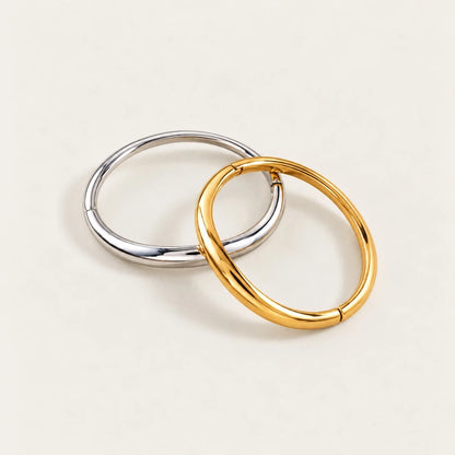 Gold and silver-tone Arco BRACELETS interlocked, smooth oval bangles on a cream background — Folie à Trois wholesale