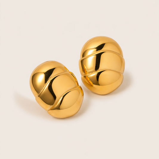 The Asher EARRINGS are chunky gold dome studs with a swirling ribbed texture for a bold, sculptural shine.