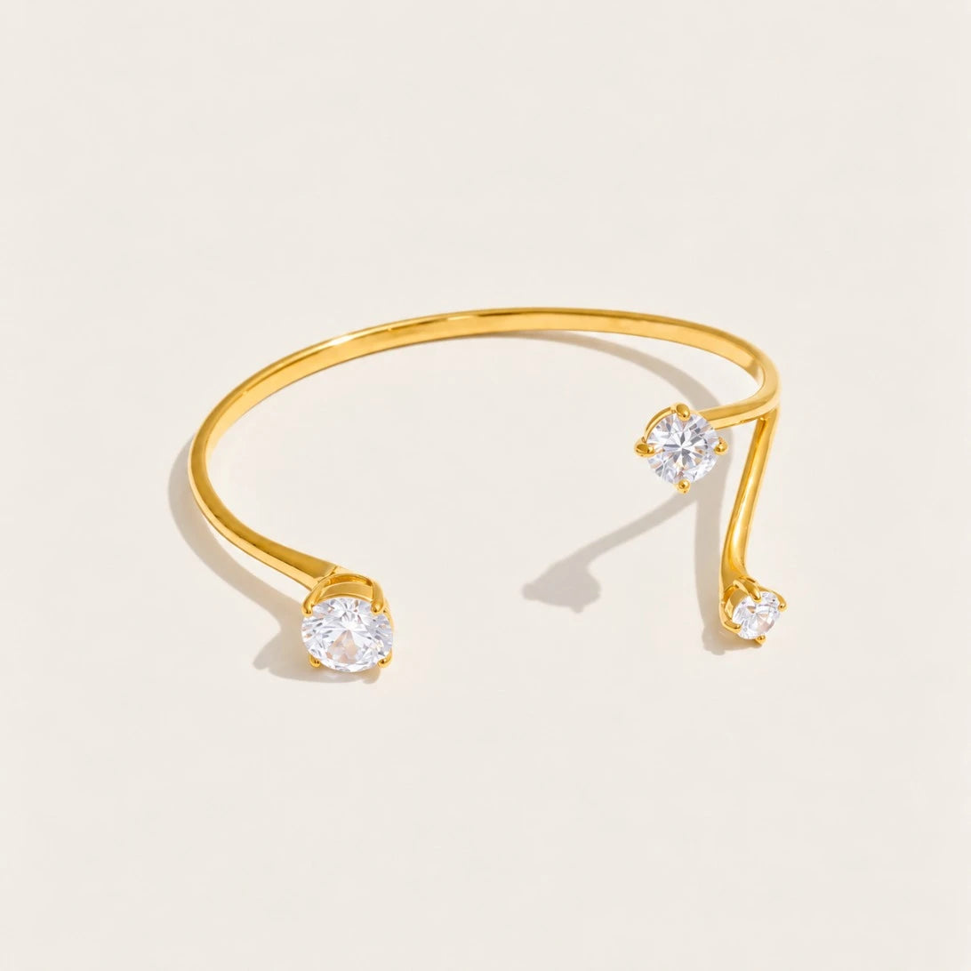 Gold Aurelia BRACELET: an open cuff bangle with a sparkling white zirconia at each end — Folie à Trois