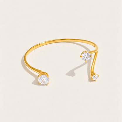 Gold Aurelia BRACELET: an open cuff bangle with a sparkling white zirconia at each end — Folie à Trois