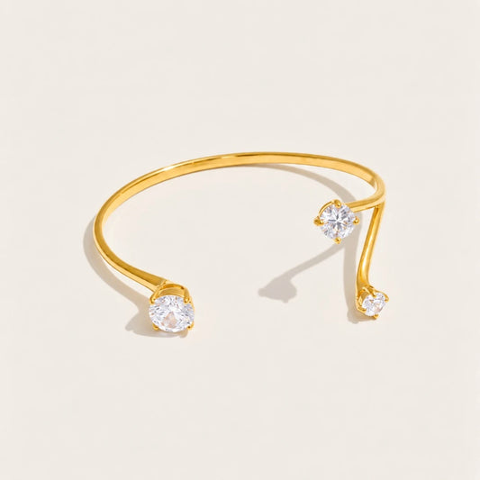 Gold Aurelia BRACELET: an open cuff bangle with a sparkling white zirconia at each end — Folie à Trois