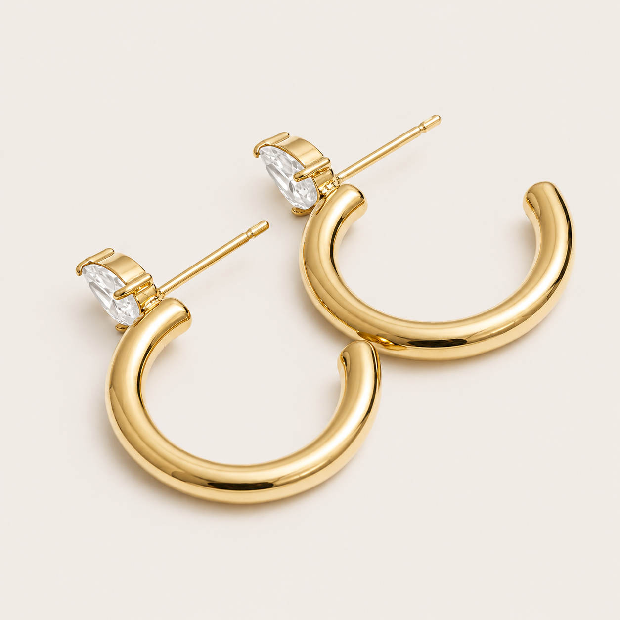 Gold chunky tube hoop earring with a marquise-cut white zirconia stone at the top — Folie à Trois Aurora EARRINGS.