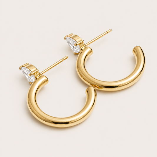 Gold chunky tube hoop earring with a marquise-cut white zirconia stone at the top — Folie à Trois Aurora EARRINGS.