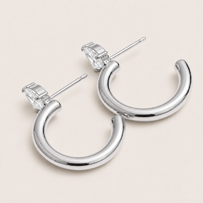 Silver chunky tube hoop earring with a marquise-cut white zirconia stone at the top — Folie à Trois Aurora EARRINGS.