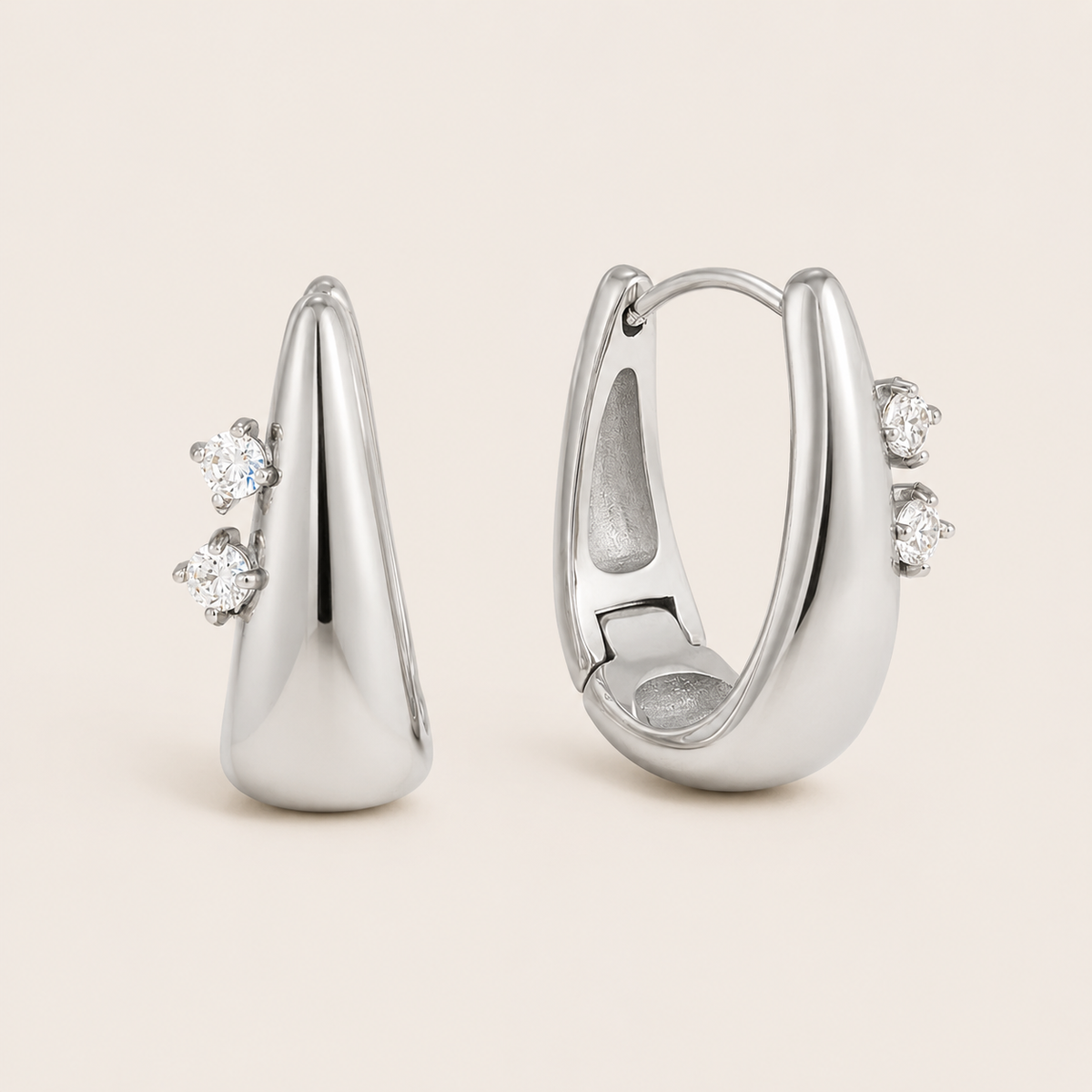 Silver Avaline EARRINGS teardrop hoops with two round cubic zirconia stones set along one edge of each hoop.