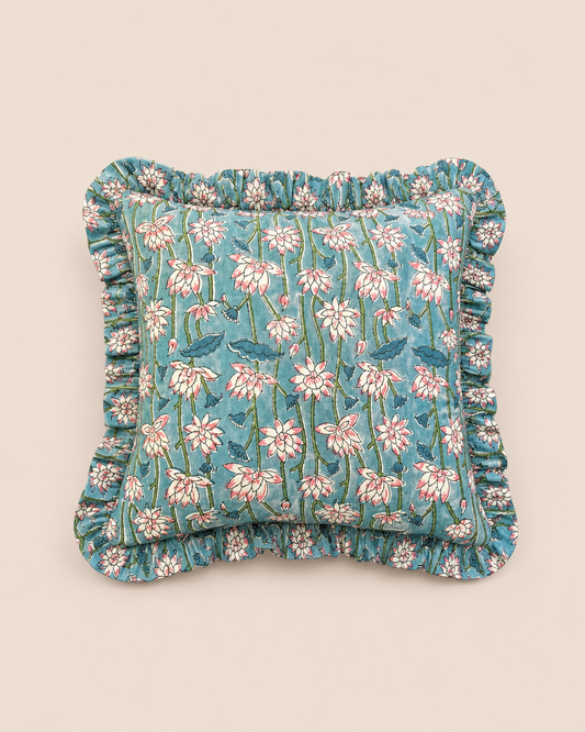 Azure Blossom Square cushion in soft blue with a hand-blocked pink and white lotus floral print, framed by a delicate ruffled edge.