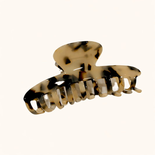 Cream and black tortoiseshell acetate claw clip from the Baby Love HAIR CLIP collection, shown on a cream studio background.