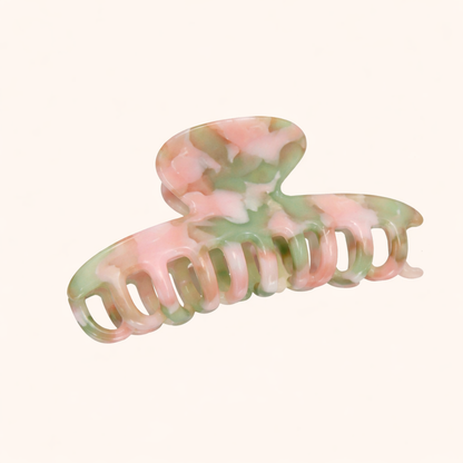 Pink and green pastel marbled acetate claw clip from the Baby Love HAIR CLIP collection, shown on a cream studio background.