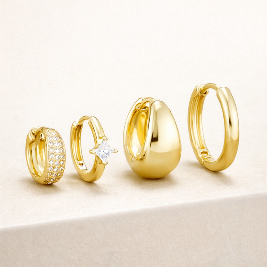 The Belle SET stacks four gold hoops: a pave huggie, a single-stone huggie, a chunky teardrop hoop, and a plain hoop.