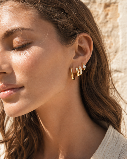 Worn along the ear outdoors, the Belle SET layers four gold hoops of varying widths and textures together.