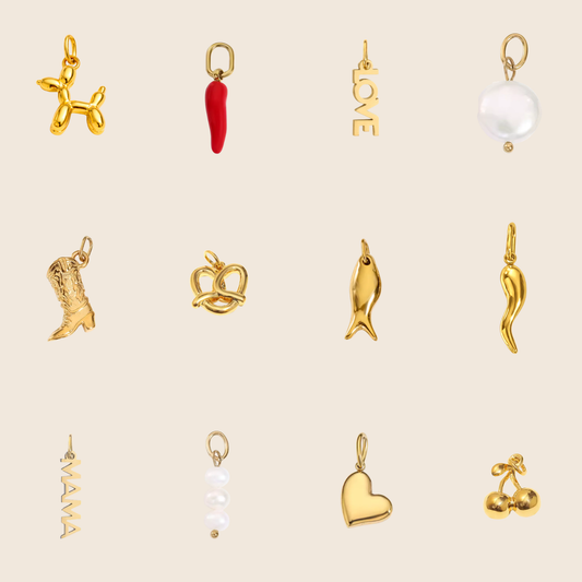 The Bestseller Charms BUNDLE laid flat, showing twelve gold charms including a balloon dog, chili, LOVE letters, pearl coin, and heart.
