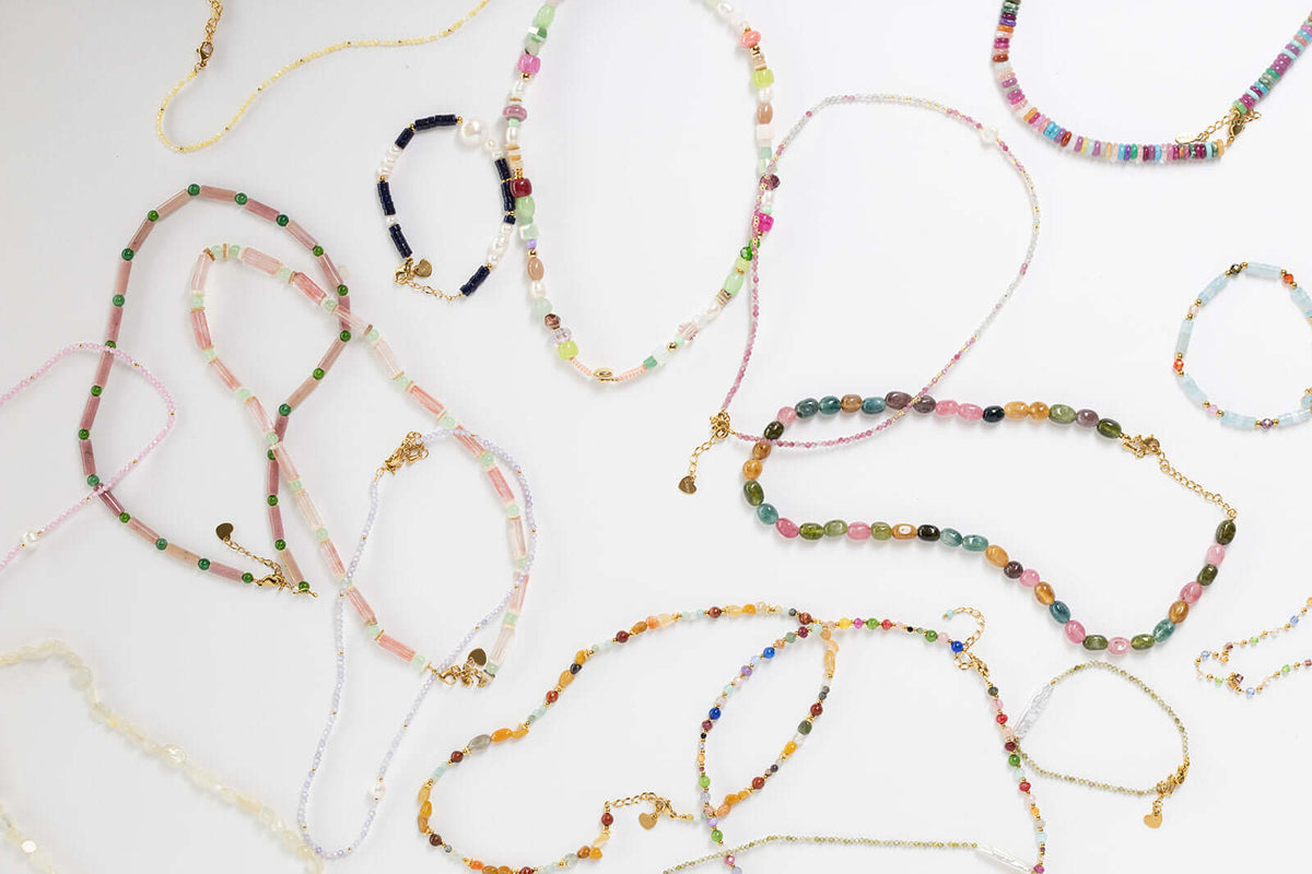 Bianca BRACELET pink and white beaded pieces shown within a wider flat-lay of assorted beaded jewelry.