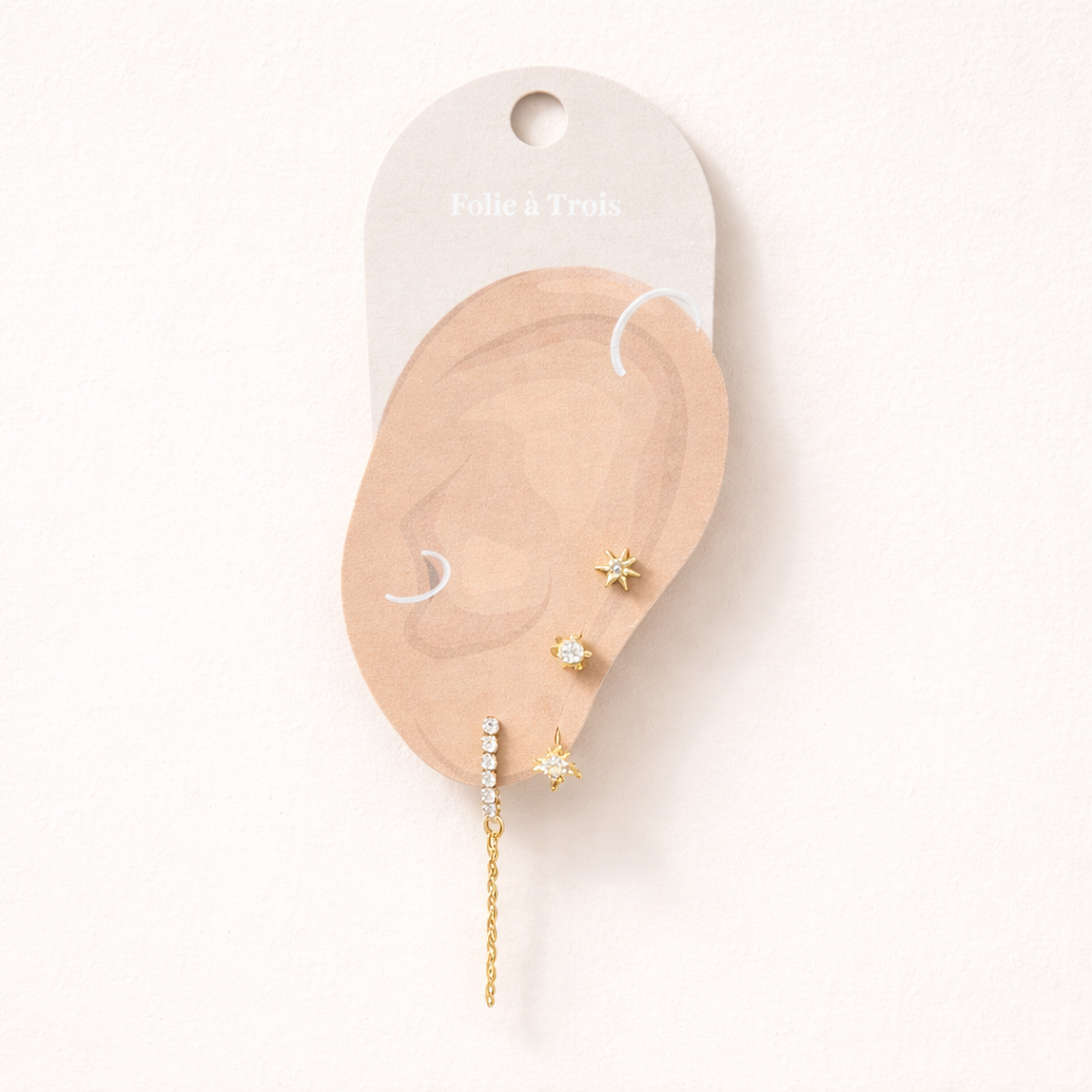 Bianca Set displayed on a Folie a Trois ear-shaped card, arranging the star stud, flower drop, and chain bar for styling.