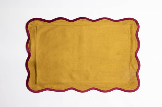 Flat lay of the Billie Rectangle Velvet cushion in mustard-gold velvet with a scalloped burgundy velvet edge on a white background.