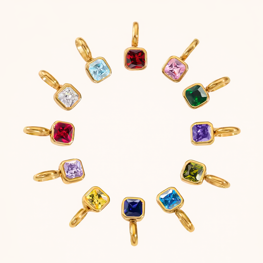 The Birthstone CHARM collection arranged in a circle, twelve square gemstone charms in gold settings representing every month.