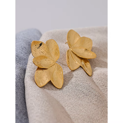 Bloom Earrings in gold on textured fabric, one shown face up and one turned to reveal the post back.