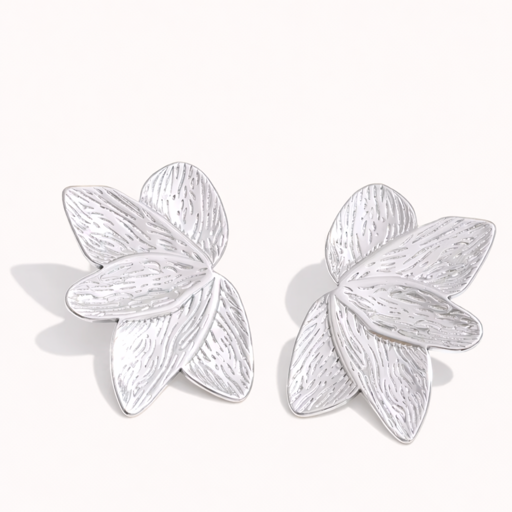 Bloom Earrings in silver tone, textured petal-shaped studs layered like a blooming flower, shown as a pair.