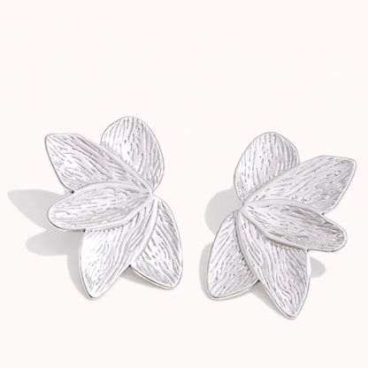 Bloom Earrings in silver tone, textured petal-shaped studs layered like a blooming flower, shown as a pair.
